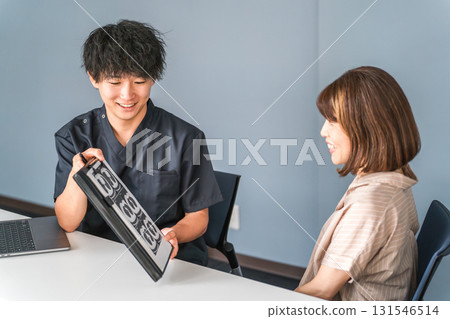 A female patient and a male doctor, nurse, and counselor having a medical examination, consultation, and counseling at a hospital A female patient and a male doctor, nurse, and counselor having a medical examination, consultation, and counseling at a hospital 131546514