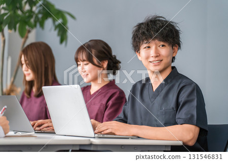 Male and female medical staff in scrubs working at their desks Male and female medical staff in scrubs working at their desks 131546831