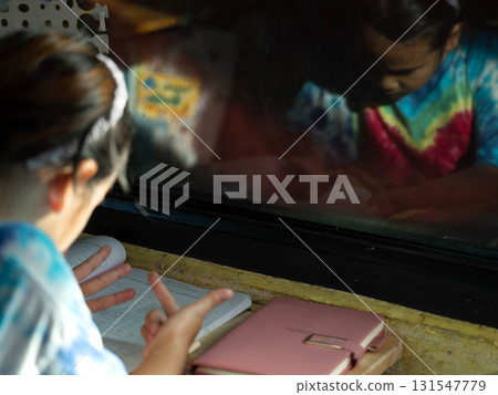 Child counting on fingers while doing math homework Child counting on fingers while doing math homework 131547779