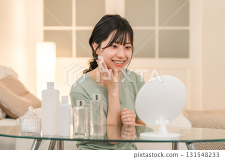 Young Asian woman doing skin care in her room at night (night care) Young Asian woman doing skin care in her room at night (night care) 131548233