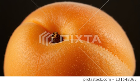 Macro close up of a fresh ripe apricot with fuzzy skin and warm orange color 131548363