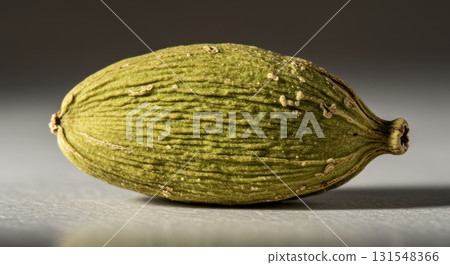 Close up macro photo of a single green cardamom pod with subtle texture and natural lighting Close up macro photo of a single green cardamom pod with subtle texture and natural lighting 131548366