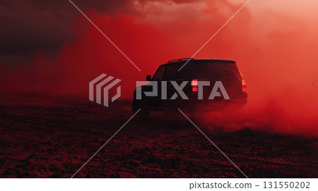 black car driving through red desert landscape under heavy skies black car driving through red desert landscape under heavy skies 131550202