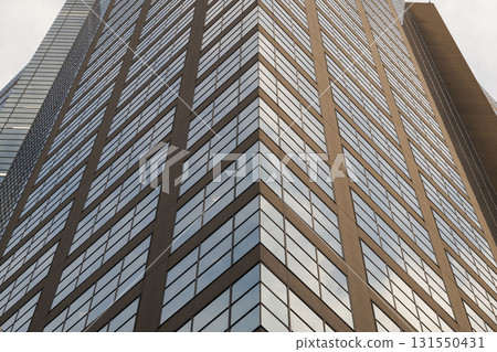 Angled perspective of tall glass-panel building Angled perspective of tall glass-panel building 131550431