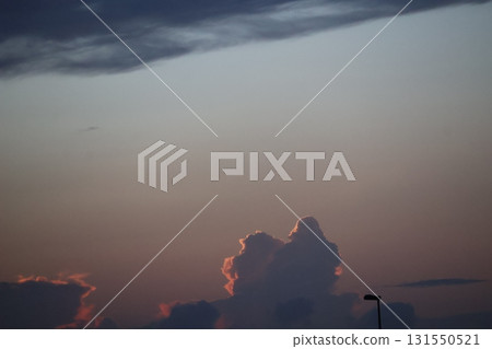 Evening sky with clouds illuminated by the setting sun 131550521