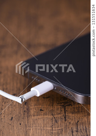 Broken smartphone charging cable 131551634