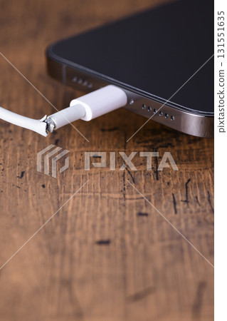 Broken smartphone charging cable 131551635