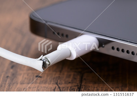 Broken smartphone charging cable 131551637