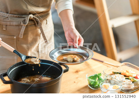 Preparing meals in a cottage/bungalow, mother/mom/housewife cooking (soup curry) Preparing meals in a cottage/bungalow, mother/mom/housewife cooking (soup curry) 131552940
