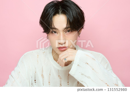 Portrait of a cute young Asian man on pink background Portrait of a cute young Asian man on pink background 131552980