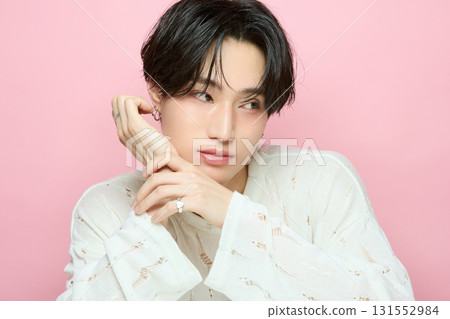 Portrait of a cute young Asian man on pink background 131552984
