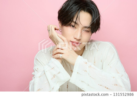 Portrait of a cute young Asian man on pink background Portrait of a cute young Asian man on pink background 131552986