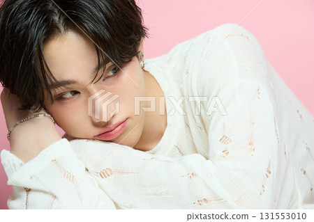 Portrait of a cute young Asian man on pink background Portrait of a cute young Asian man on pink background 131553010