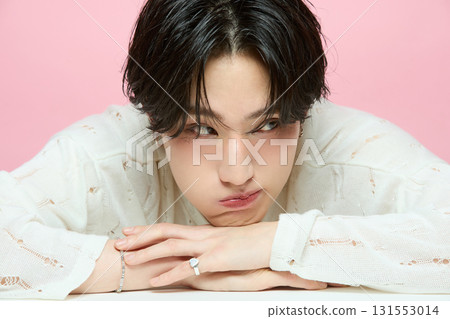 Portrait of a cute young Asian man on pink background Portrait of a cute young Asian man on pink background 131553014