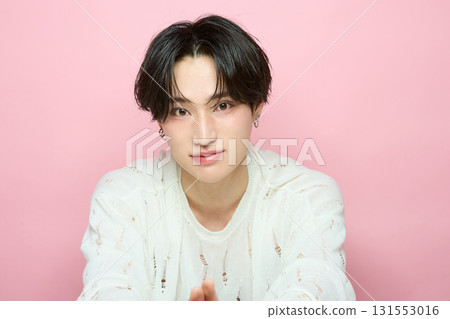 Portrait of a cute young Asian man on pink background Portrait of a cute young Asian man on pink background 131553016