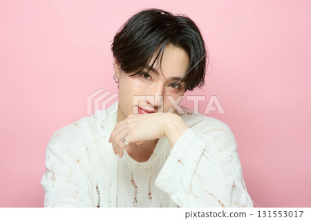 Portrait of a cute young Asian man on pink background Portrait of a cute young Asian man on pink background 131553017