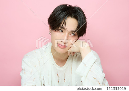 Portrait of a cute young Asian man on pink background Portrait of a cute young Asian man on pink background 131553019