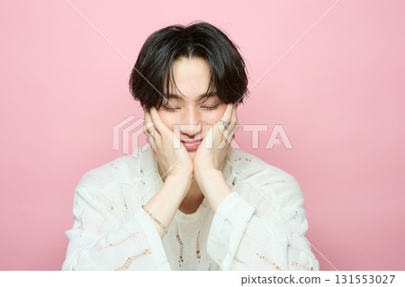 Portrait of a cute young Asian man on pink background Portrait of a cute young Asian man on pink background 131553027