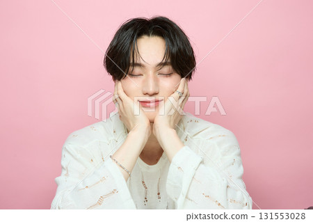 Portrait of a cute young Asian man on pink background Portrait of a cute young Asian man on pink background 131553028