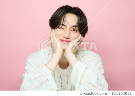Portrait of a cute young Asian man on pink background Portrait of a cute young Asian man on pink background 131553031