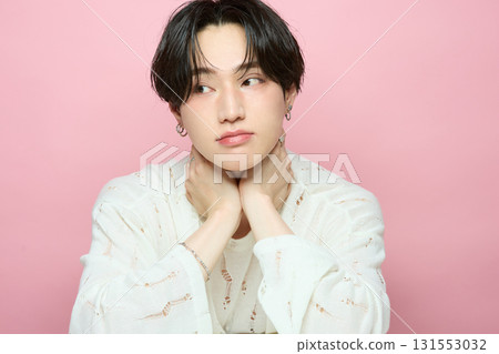 Portrait of a cute young Asian man on pink background Portrait of a cute young Asian man on pink background 131553032