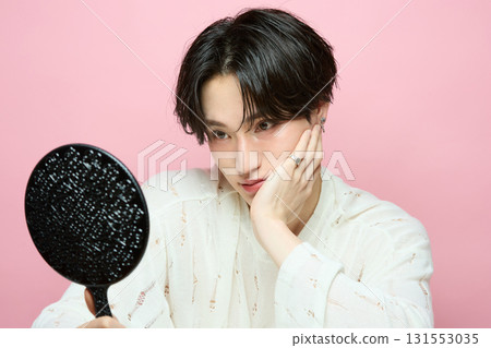 Portrait of a cute young Asian man on pink background 131553035