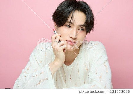 Portrait of a cute young Asian man on pink background Portrait of a cute young Asian man on pink background 131553036