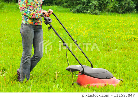 Mowing lawns, lawn mower on green grass Mowing lawns, lawn mower on green grass 131553047