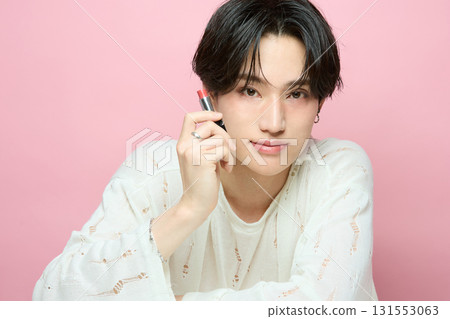 Portrait of a cute young Asian man on pink background 131553063