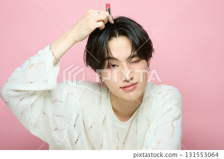 Portrait of a cute young Asian man on pink background Portrait of a cute young Asian man on pink background 131553064