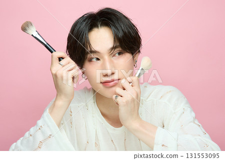 Portrait of a cute young Asian man on pink background Portrait of a cute young Asian man on pink background 131553095