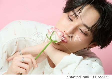 Portrait of a cute young Asian man on pink background 131553132