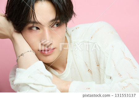 Portrait of a cute young Asian man on pink background Portrait of a cute young Asian man on pink background 131553137