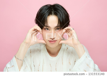 Portrait of a cute young Asian man on pink background 131553140