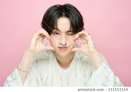 Portrait of a cute young Asian man on pink background 131553154