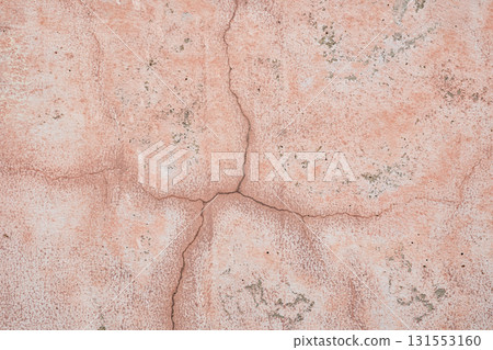 Pink concrete wall texture with faded and cracked geometric pattern. 131553160