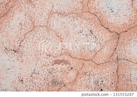 Pink concrete wall texture with faded and cracked geometric pattern. 131553287
