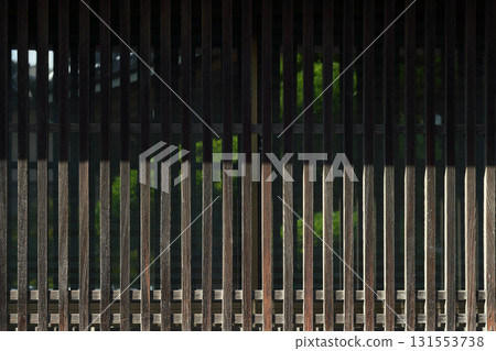 Buildings and plants seen through a lattice screen. Background material of traditional Japanese architecture Buildings and plants seen through a lattice screen. Background material of traditional Japanese architecture 131553738