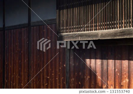 Burnt cedar plank wall and lattice screen. Background material of traditional Japanese architecture Burnt cedar plank wall and lattice screen. Background material of traditional Japanese architecture 131553740