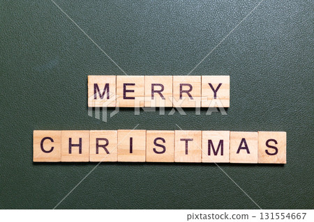 Merry Christmas text made of wooden letter blocks on green background 131554667