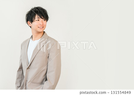 Smiling young Asian businessman in a suit or jacket (office casual, refreshing, job change, employment) Smiling young Asian businessman in a suit or jacket (office casual, refreshing, job change, employment) 131554849