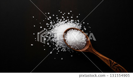 Salt in Wooden Spoon on Dark Background 131554905