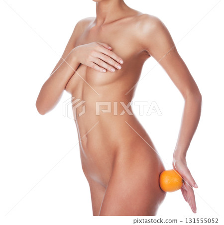 Naked woman with slim sexy body holding big orange, isolated on white background Naked woman with slim sexy body holding big orange, isolated on white background 131555052