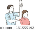 A male chiropractor treating a female patient's arms and shoulders 131555192