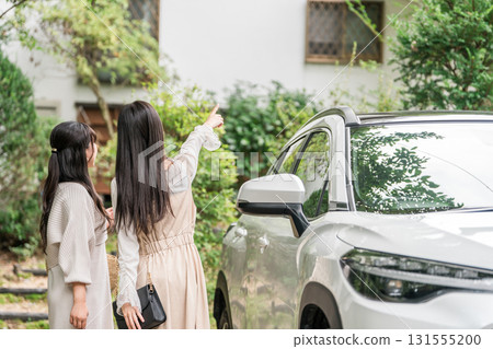 A woman who arrived at a guesthouse, cottage, or vacation rental by car A woman who arrived at a guesthouse, cottage, or vacation rental by car 131555200