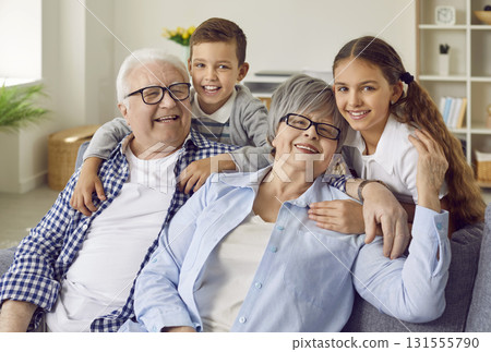 Portrait of happy, smiling grandparents together with grandson and granddaughter Portrait of happy, smiling grandparents together with grandson and granddaughter 131555790