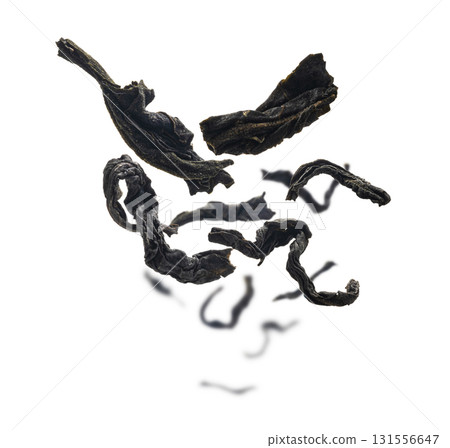Dried black tea close up levitating on white background Dried black tea close up levitating on white background 131556647