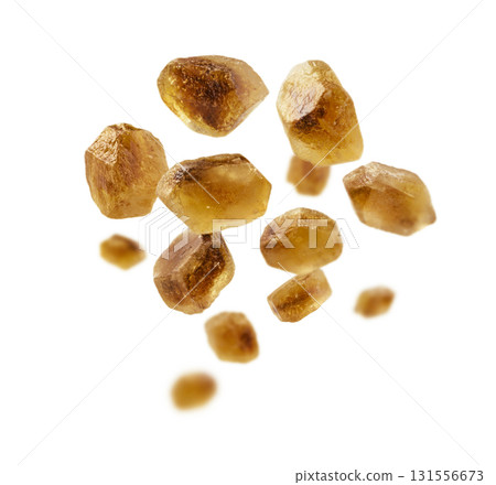 Caramelized sugar levitates on a white background Caramelized sugar levitates on a white background 131556673