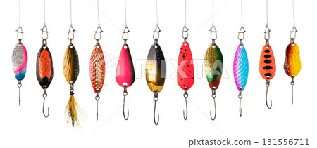 Colorful fishing lures hanging on white background displaying sharp hooks Colorful fishing lures hanging on white background displaying sharp hooks 131556711
