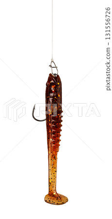 Brown soft plastic fishing lure hanging on a fishing line Brown soft plastic fishing lure hanging on a fishing line 131556726